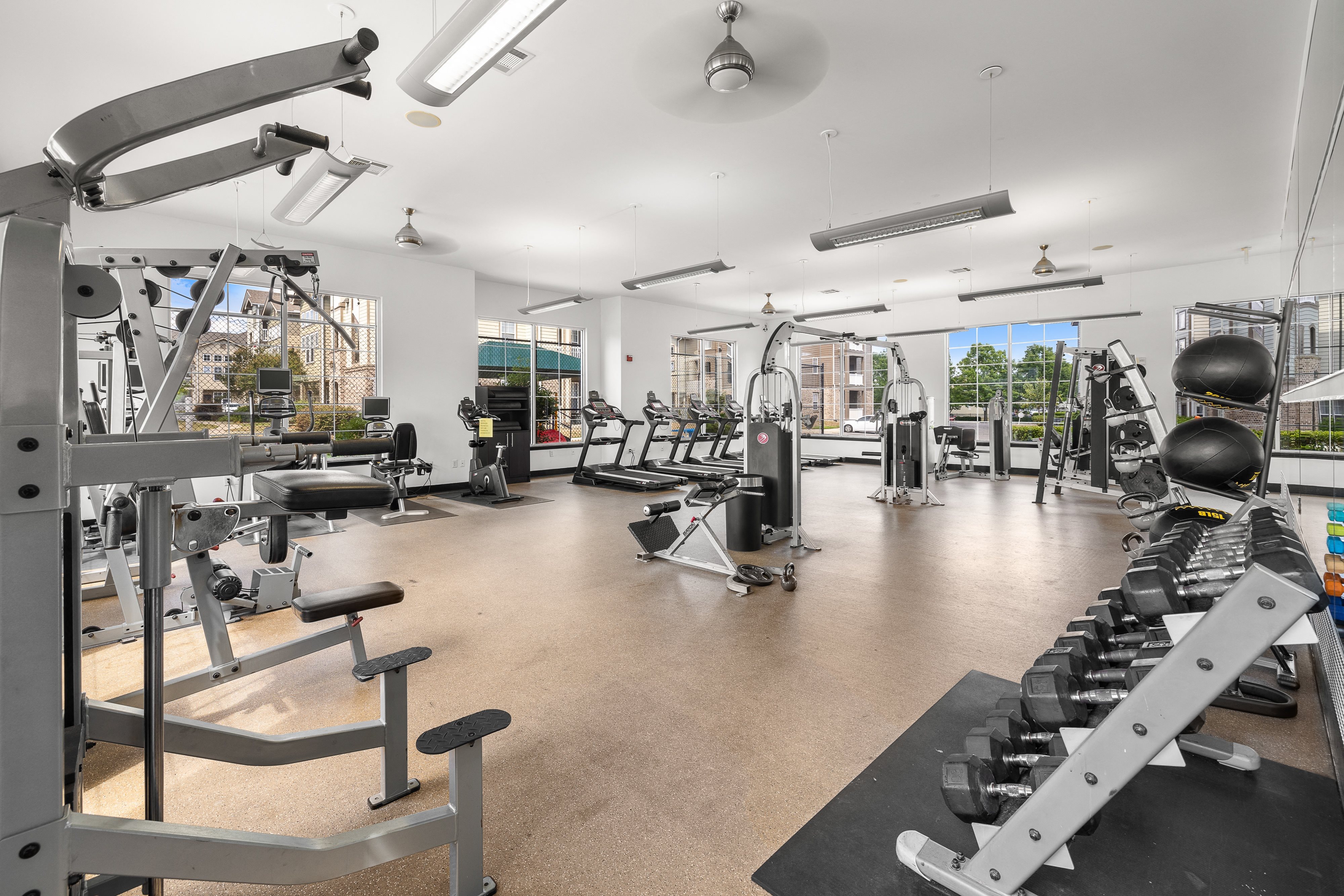 a gym with weights and other exercise equipment in a large room